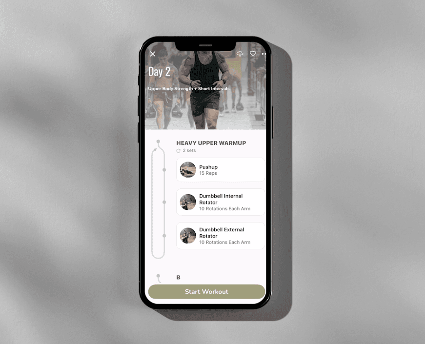 Smartphone displaying a fitness app with Day 2 workout plan and exercises listed.